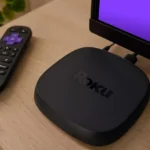 IPTV on Roku: streaming player and remote beside a television