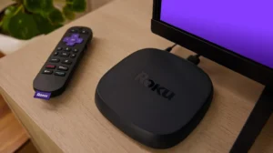 IPTV on Roku: streaming player and remote beside a television